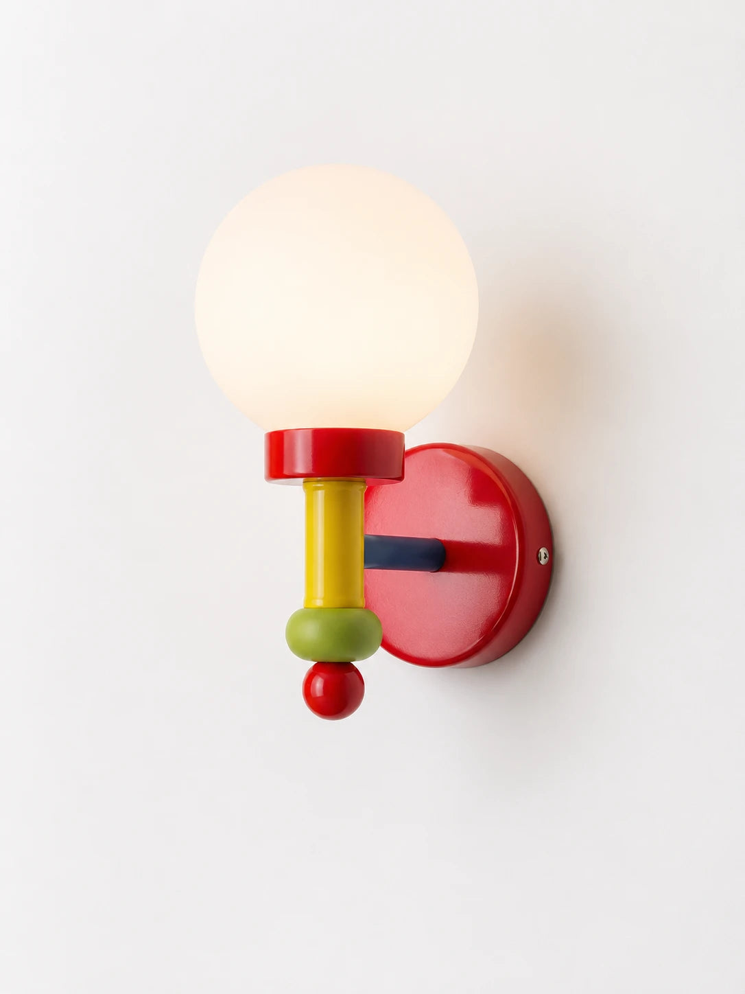 red wall lamp with a white globe shade and yellow, green and red accents