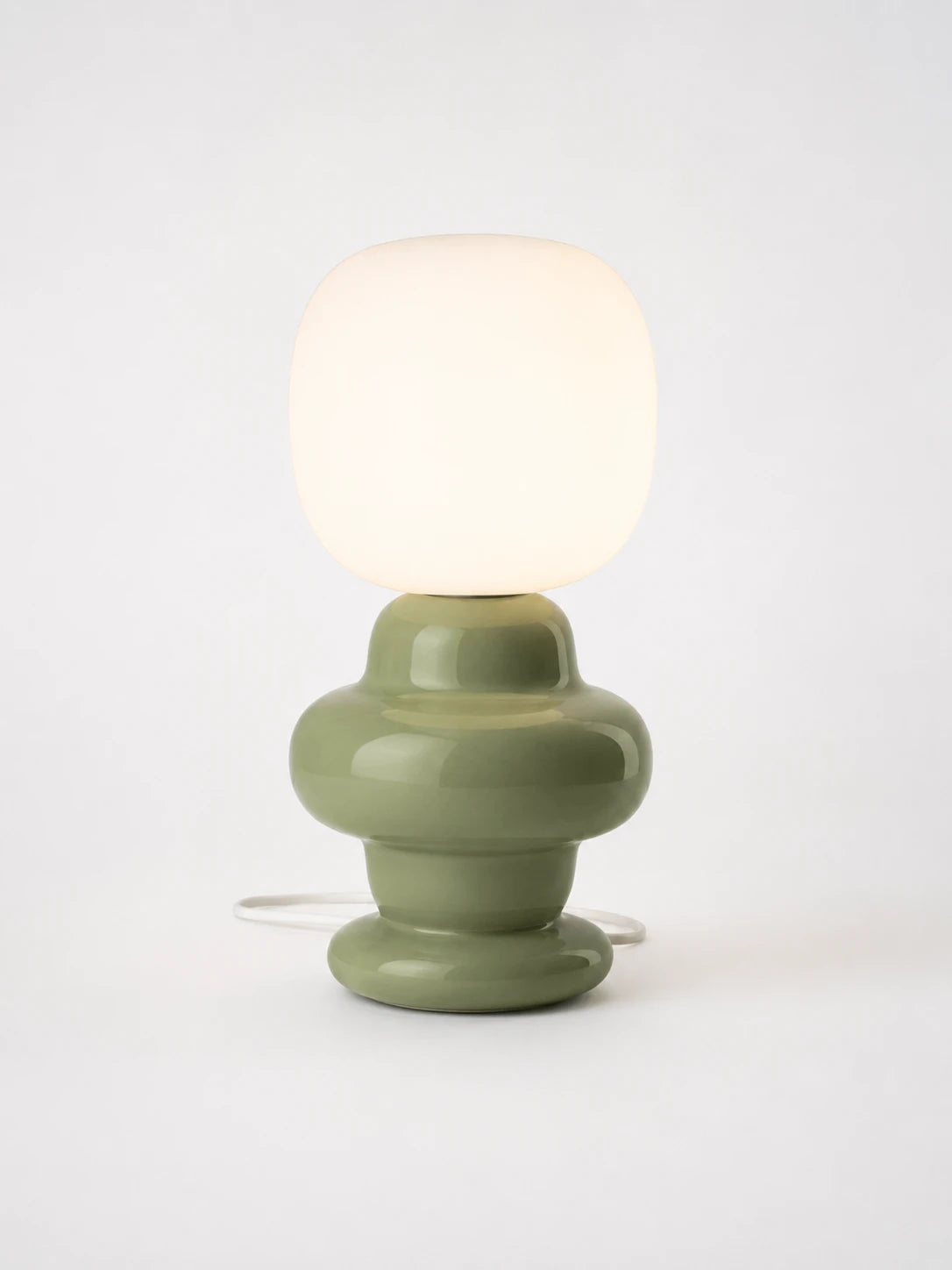sage green ceramic table lamp with a bulbous stacked base and square frosted glass shade