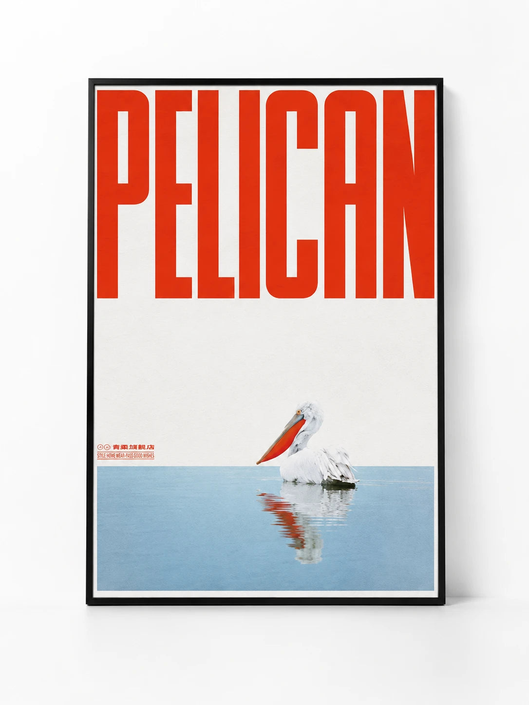 framed poster with the bold red word Pelican over a white pelican floating on pale blue water