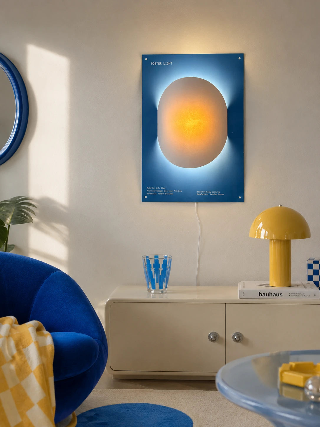 poster night light glowing on a cream console in an entryway beside a blue velvet chair