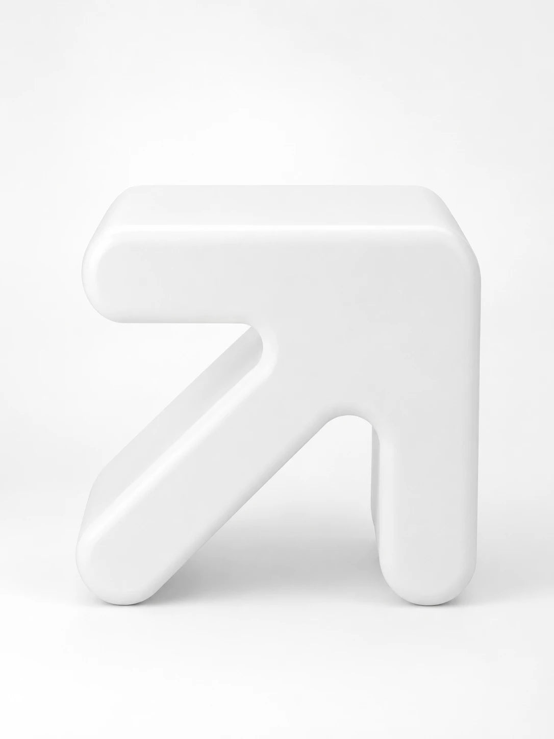 glossy white rotomolded plastic stool shaped like a chunky arrow pointing up and to the right