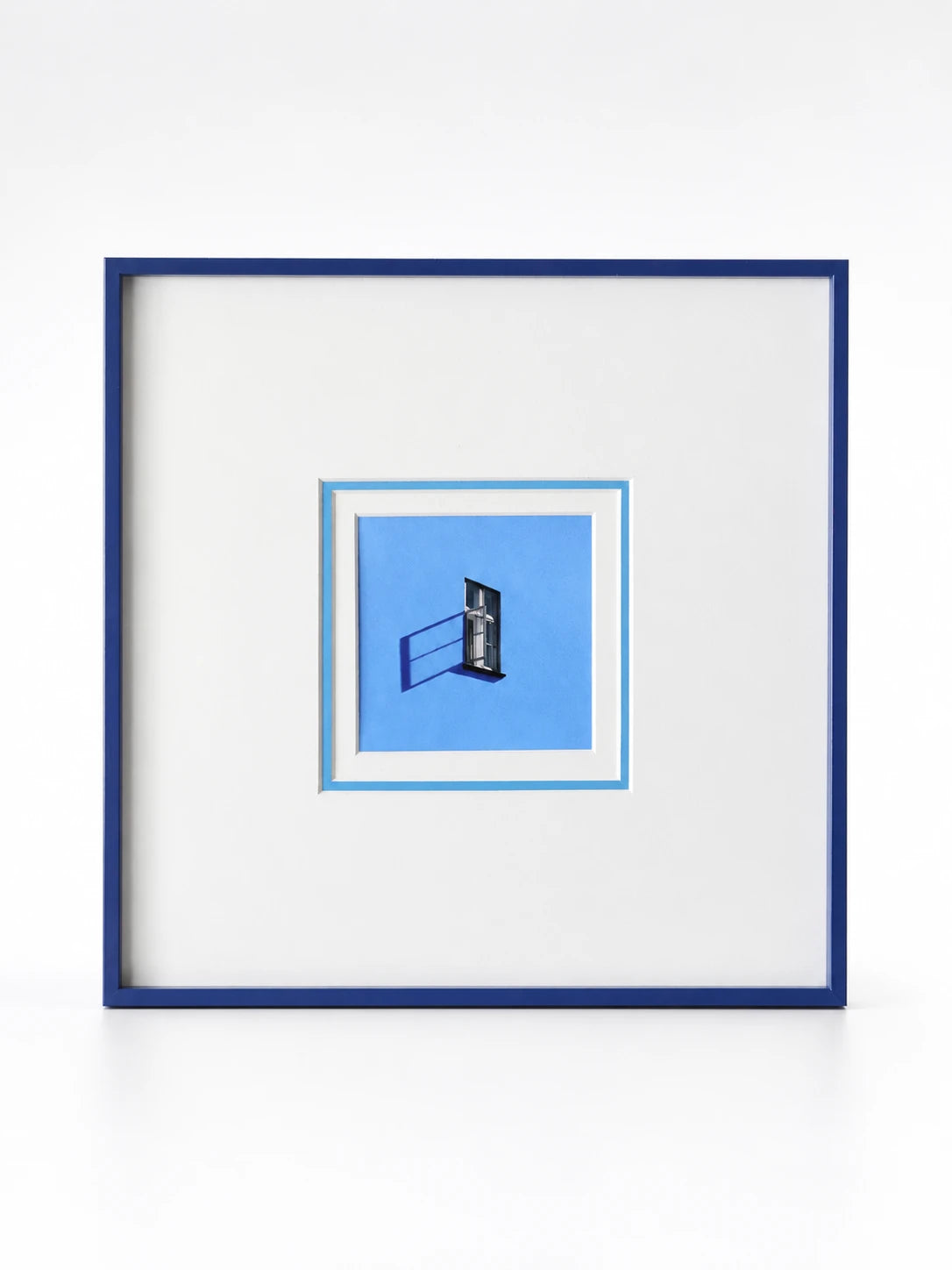 small canvas print of an open window on periwinkle blue, floated in a wide white mat and navy frame