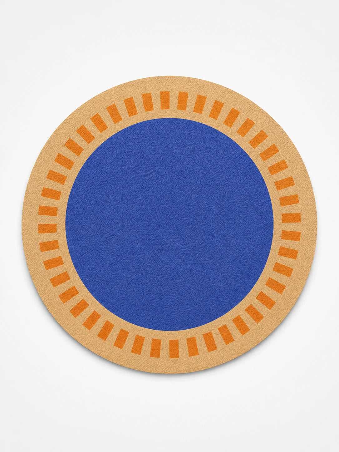 sand-coloured round placemat with orange ticks and a cobalt-blue centre, studio shot