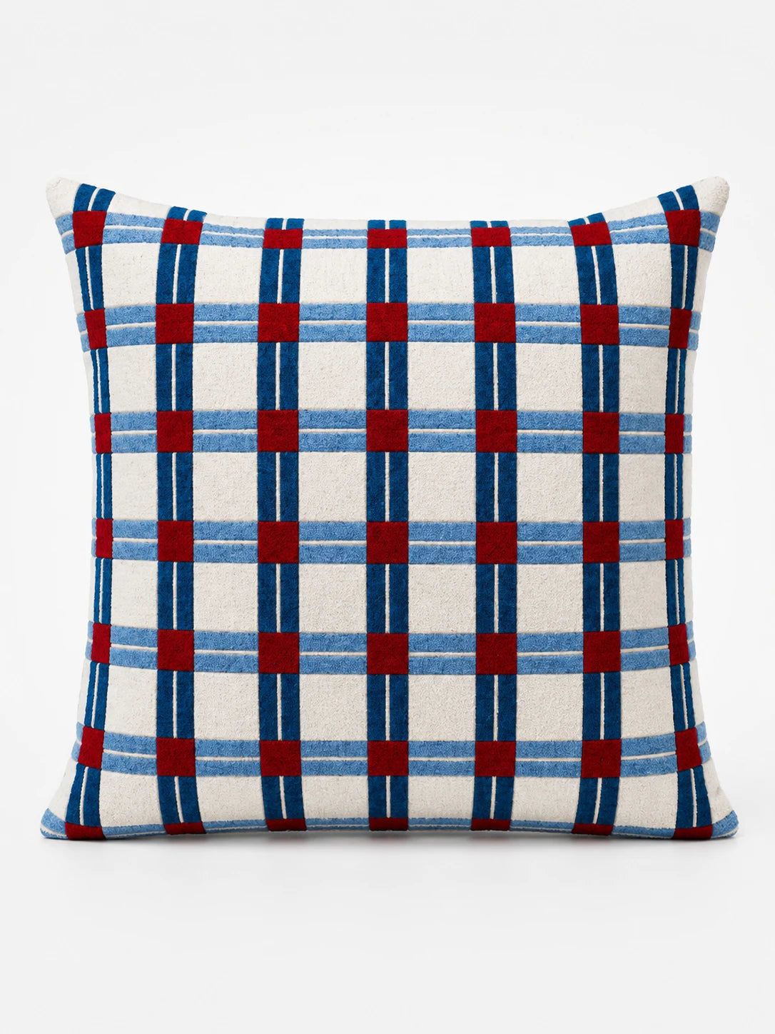 cream square cushion with a navy and light-blue windowpane check and red squares at the intersections