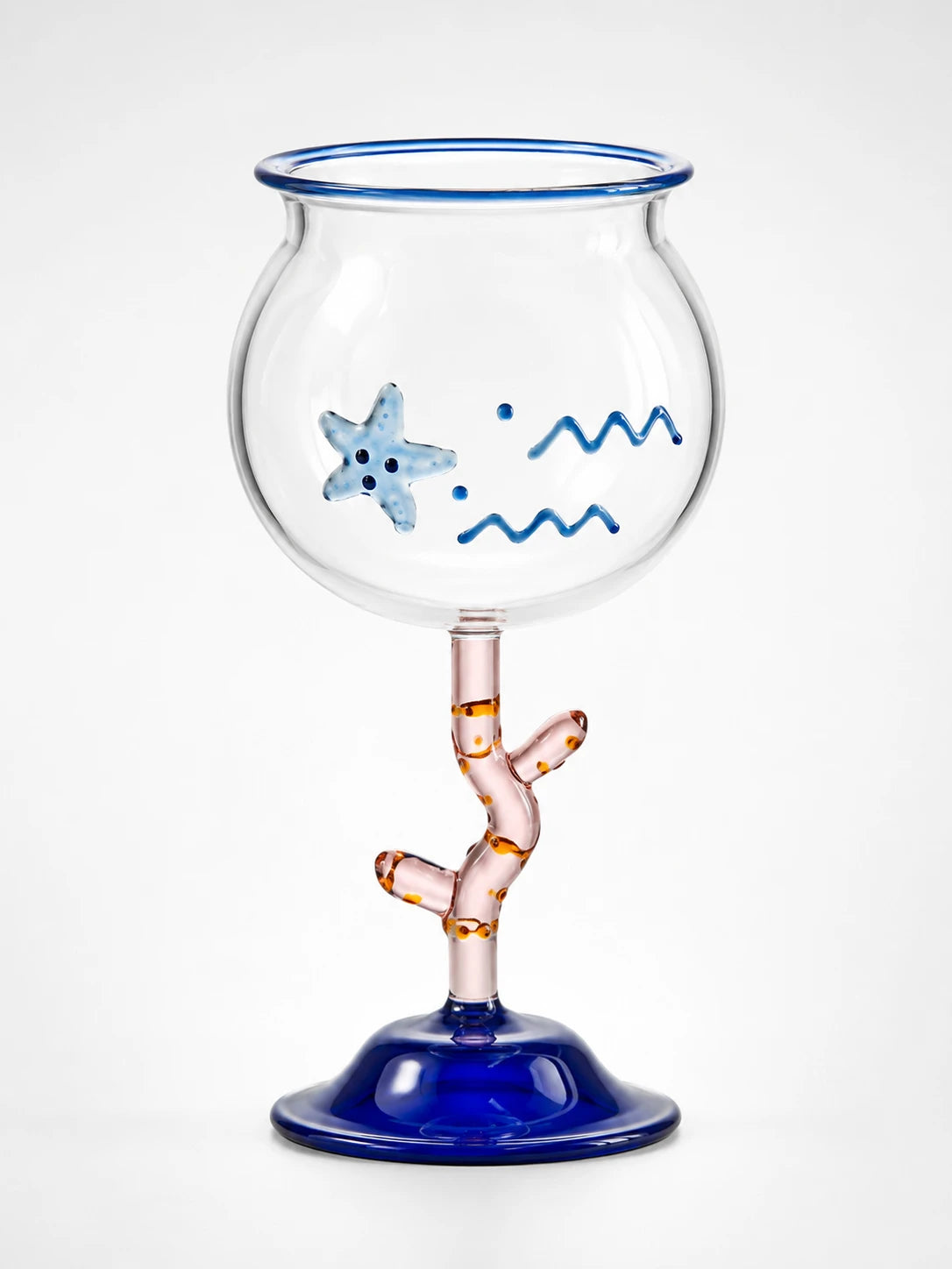 clear fishbowl cocktail glass with raised blue starfish and wave motifs, pink coral stem and cobalt blue bell foot