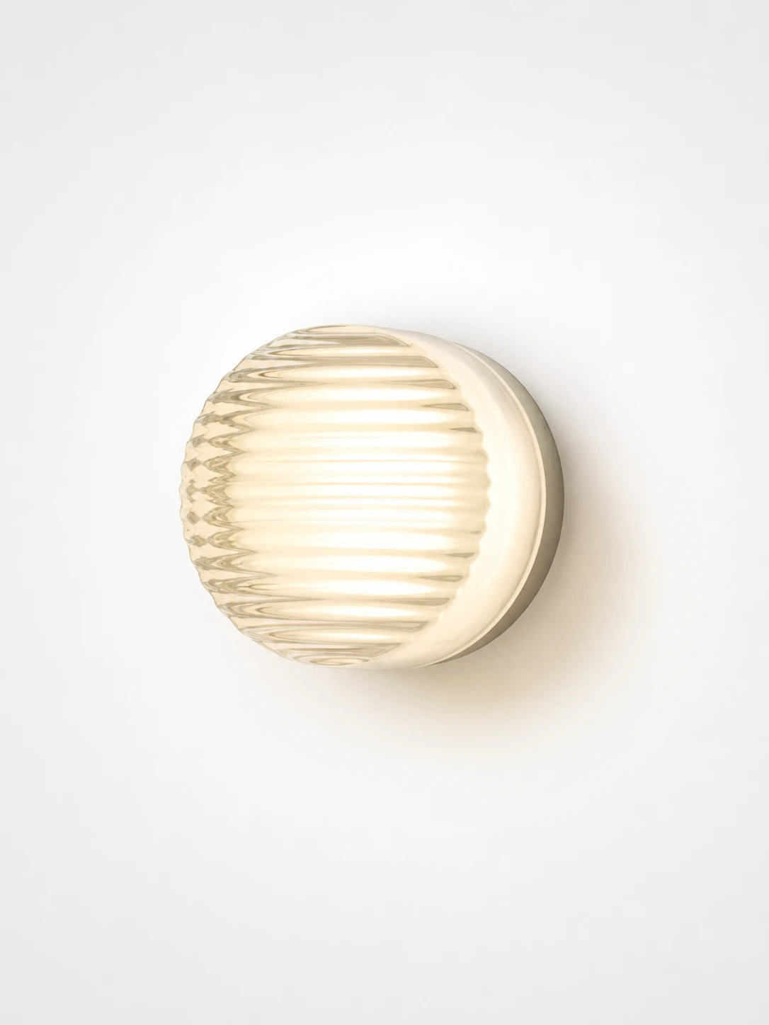 amber acrylic disk wall lamp glowing in a hallway