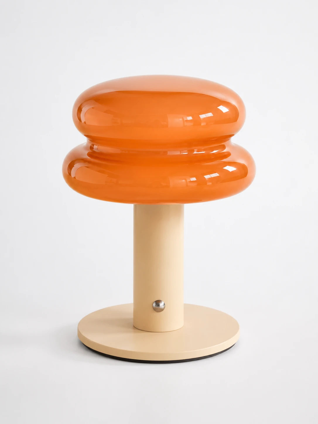 orange stacked macaron glass cordless lamp with cream stem and base on white background