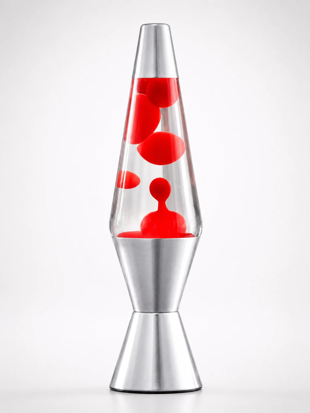 retro lava lamp with clear liquid and red wax blobs in a tapered glass body on a silver aluminum base