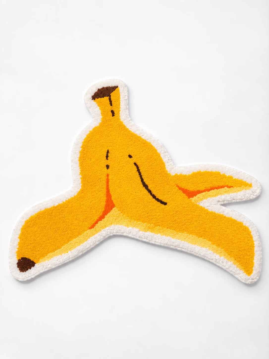 Banana peel shaped plush floor mat with sleepy face and white border, flat product view