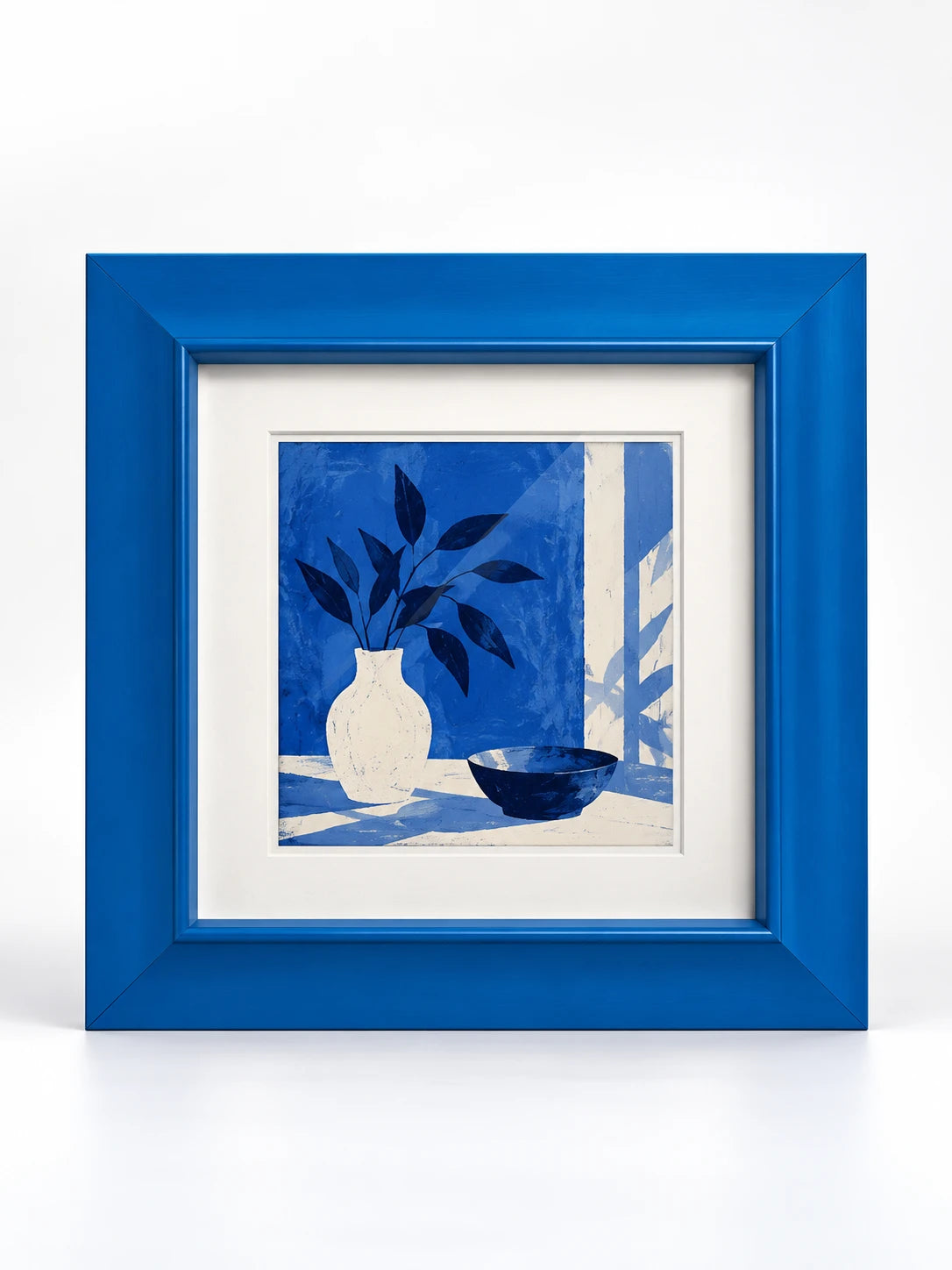 cobalt blue solid wood picture frame with wide bevelled border and blue still life print, studio view