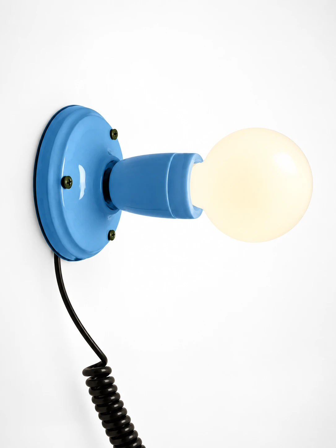 sky blue ceramic wall light with an opal globe bulb and coiled black cord, studio shot on white