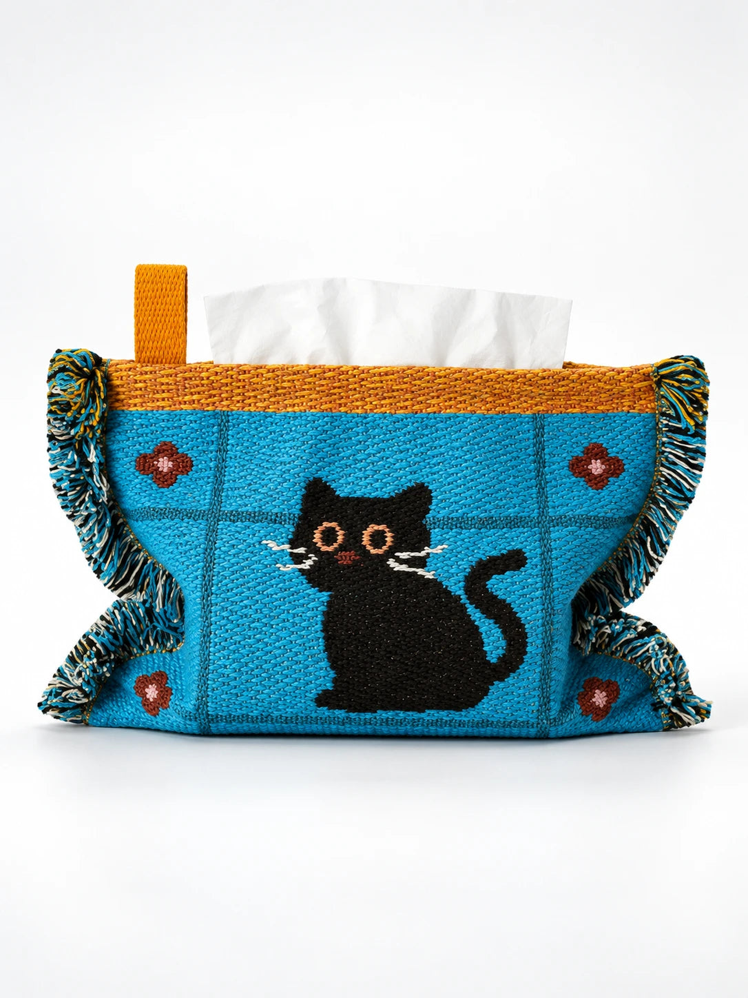 blue knitted tissue holder with black cat design, mustard trim and tassels, studio view