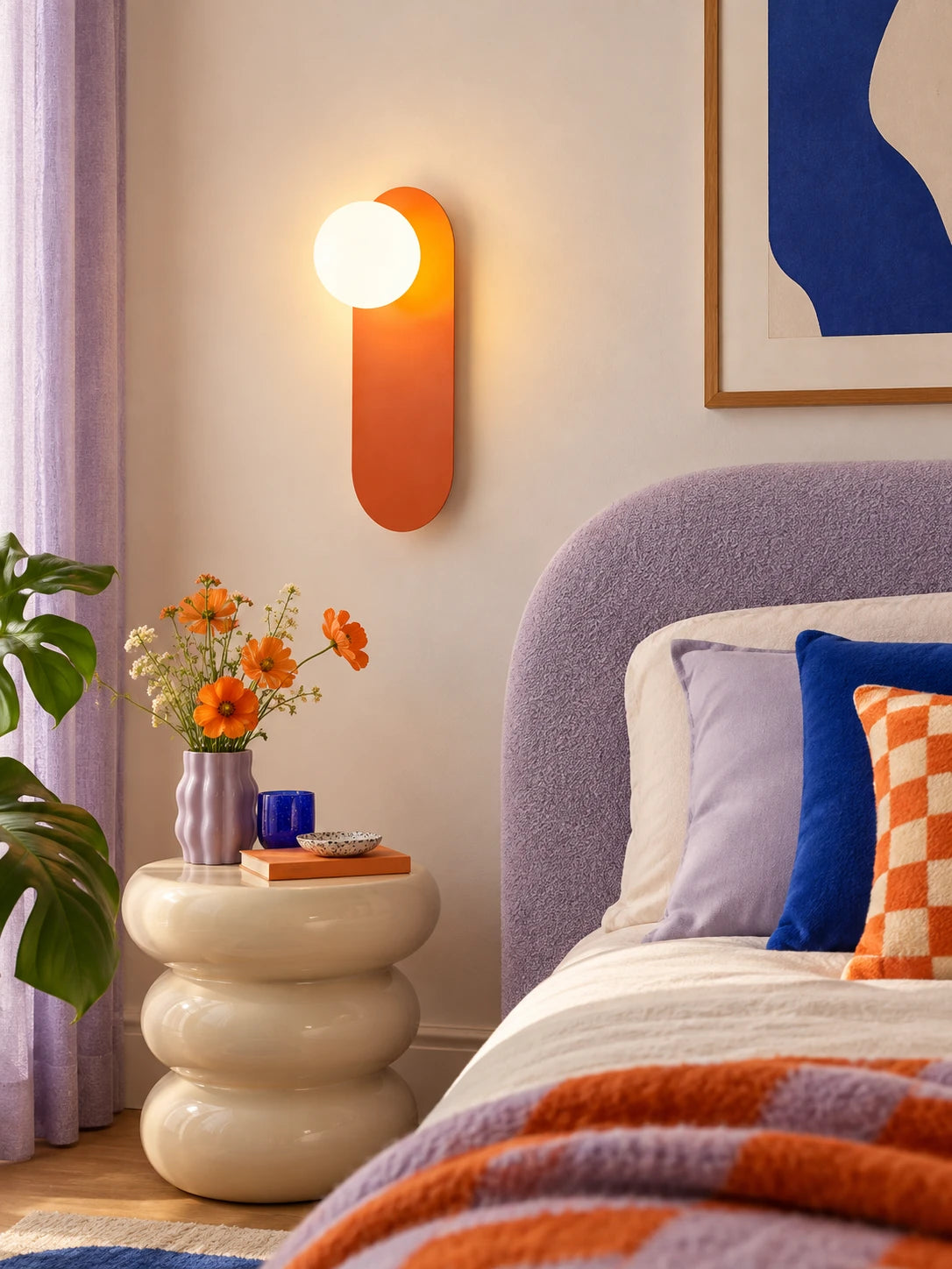 Warm wall lamp lighting a cozy reading corner with an armchair