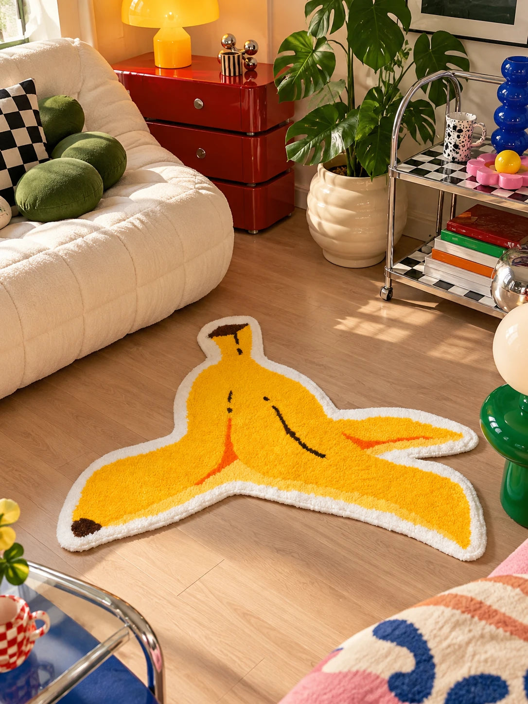 Banana peel mat in front of a cream sofa with red retro drawer cabinet and bar cart