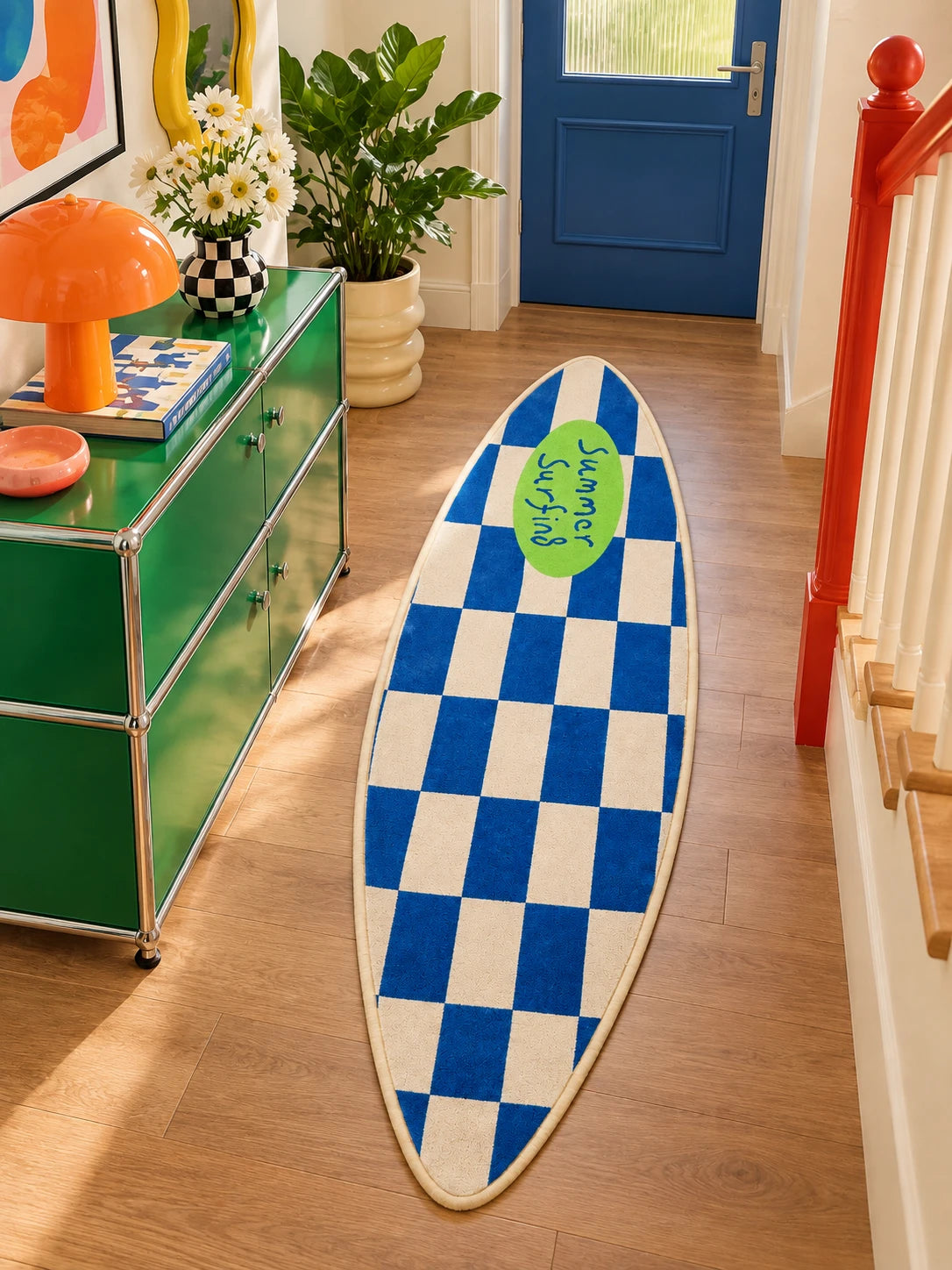 Blue surfboard runner rug in an entry hall beside a green storage cabinet and daisy bouquet