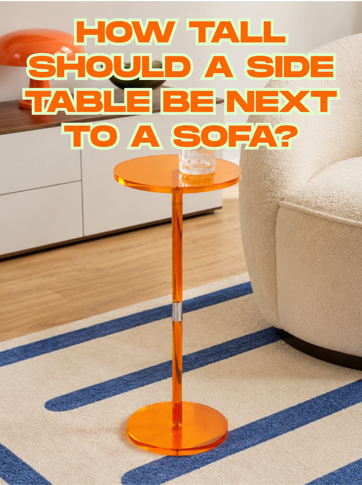 Slim orange acrylic pedestal side table holding a glass beside a cream boucle armchair on a striped rug, with the title How Tall Should a Side Table Be Next to a Sofa?