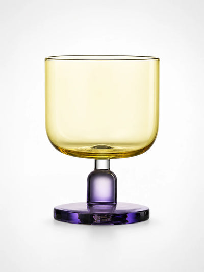 yellow glass tumbler with a purple stem and round base