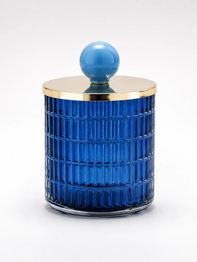 cobalt blue ribbed glass storage jar with a gold-tone metal lid and sky-blue ceramic ball knob