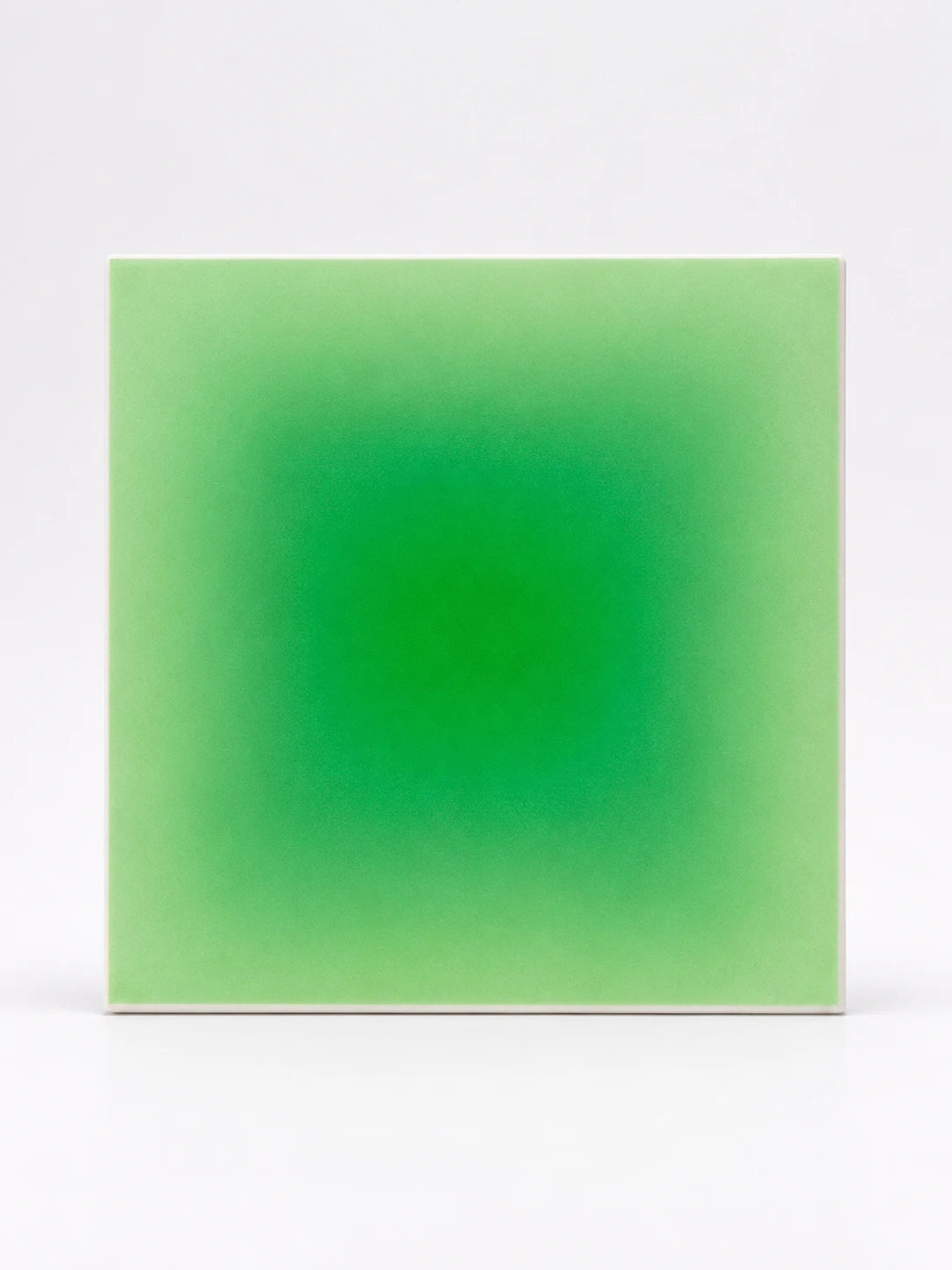 square felt panel with a bright green radial gradient fading to pale mint at the edges