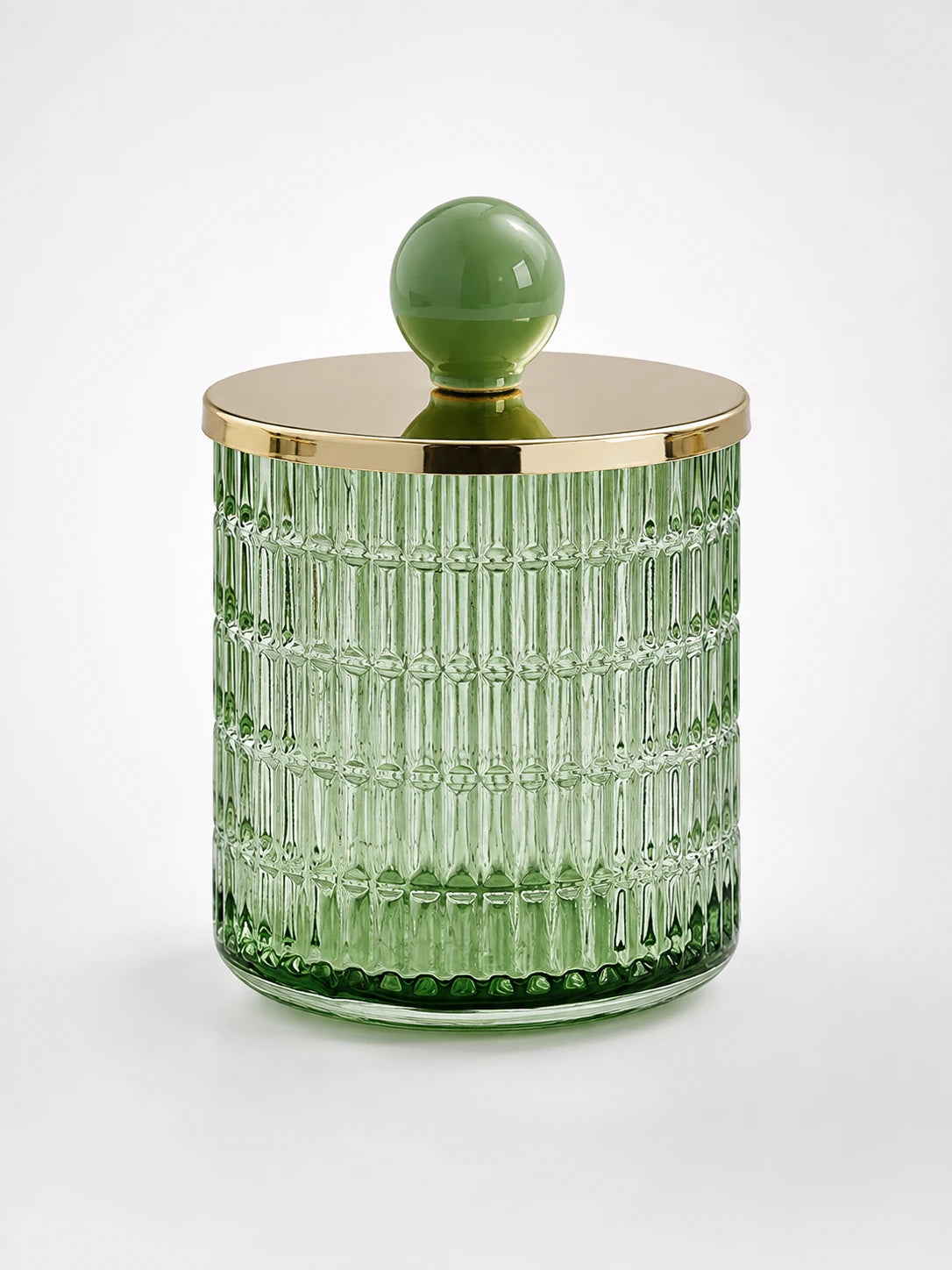 green ribbed glass storage jar with woven-node pattern, gold-tone metal lid and sage ceramic ball knob