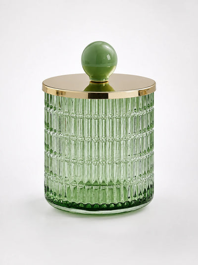green ribbed glass storage jar with woven-node pattern, gold-tone metal lid and sage ceramic ball knob