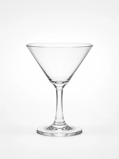 clear stemmed martini glass with conical bowl photographed on a plain white background