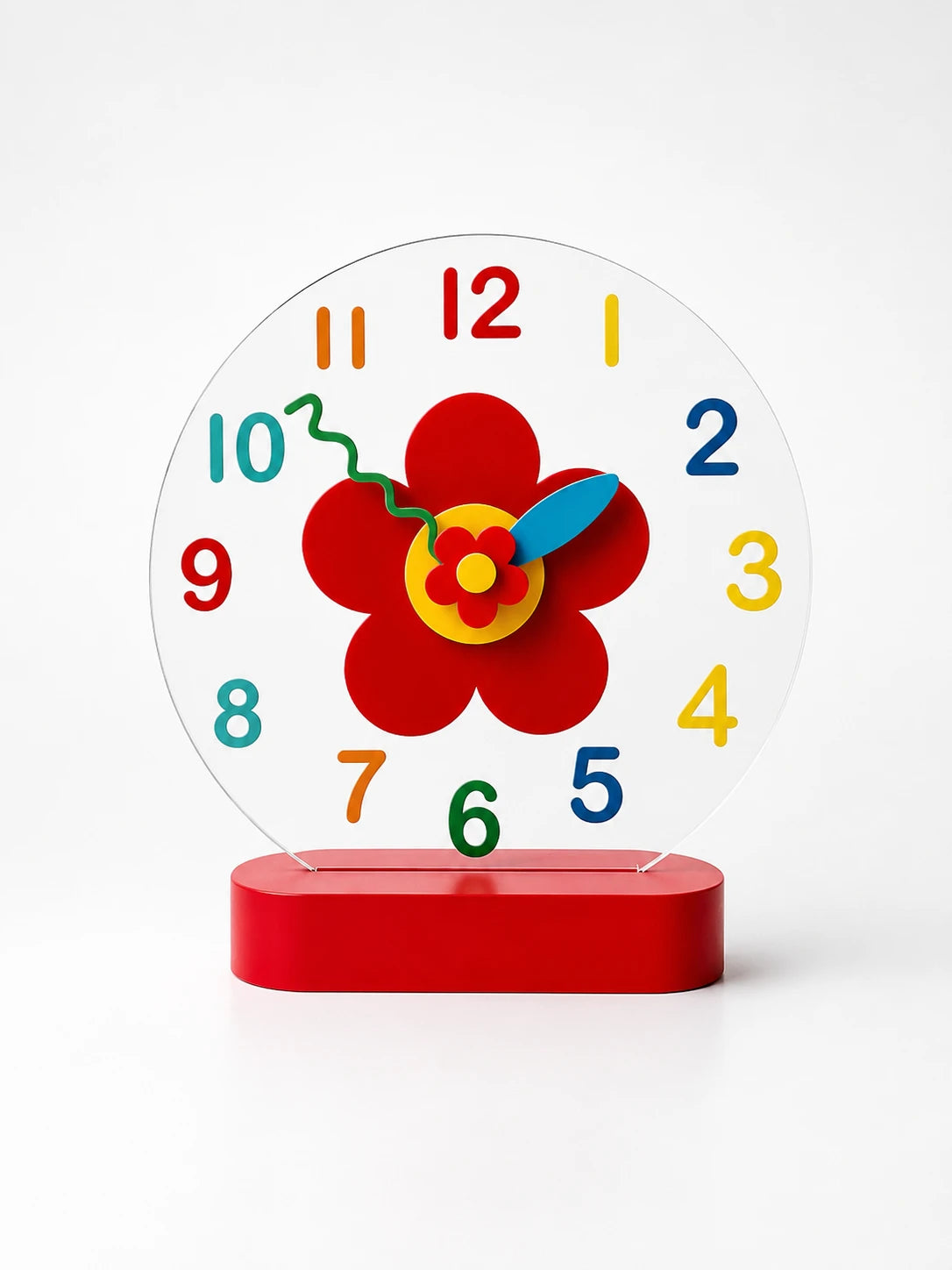 red five-petal flower desk clock with rainbow numerals on a clear round face and red oval base