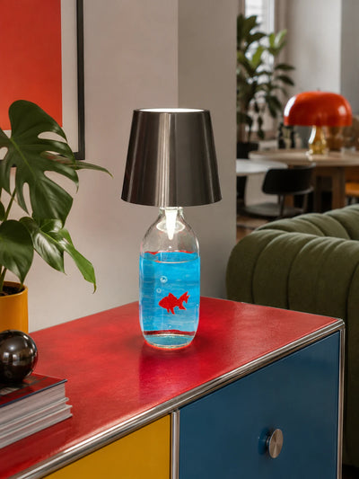 goldfish bottle lamp lit warm white on a red and blue credenza in a colorful living room