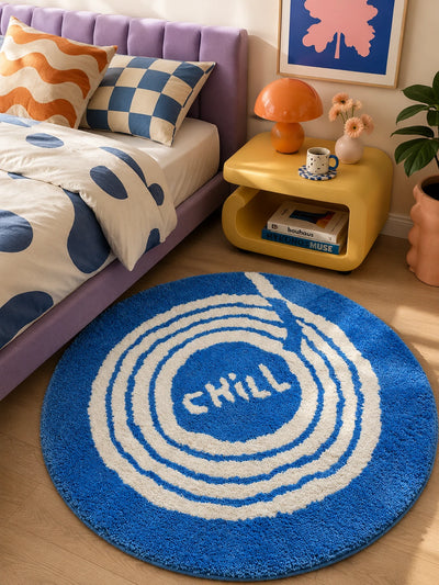 round chill record rug beside a purple bed frame and yellow nightstand with an orange mushroom lamp