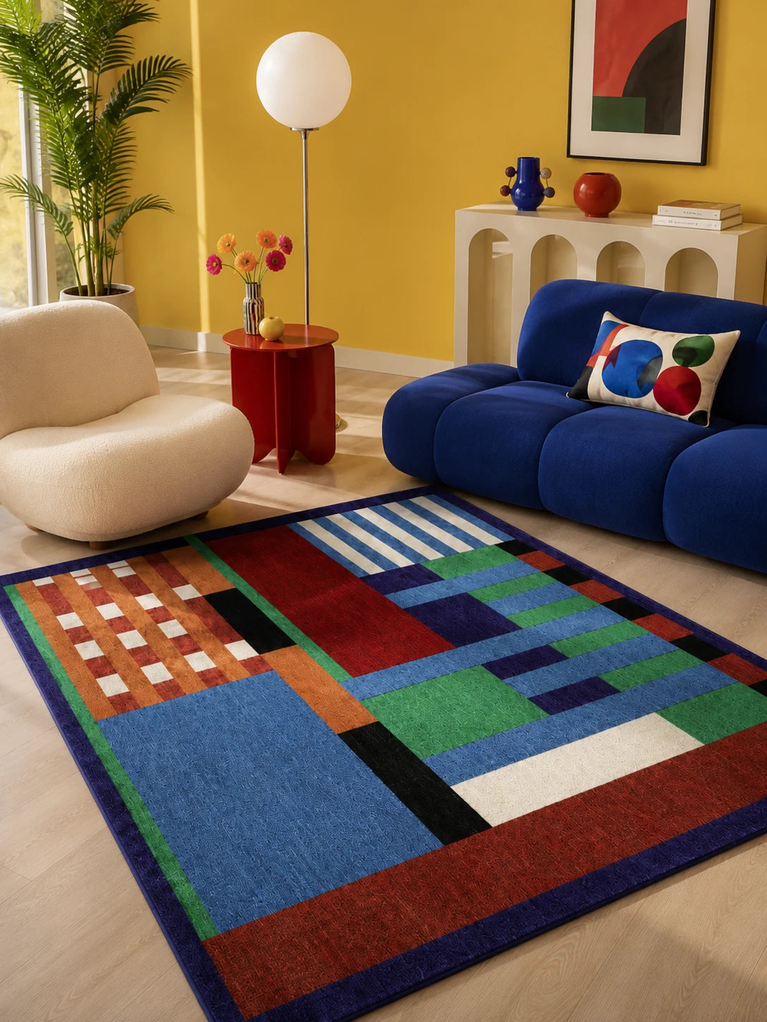 geometric color-block rug beside a cobalt blue sofa and cream armchair against a yellow wall