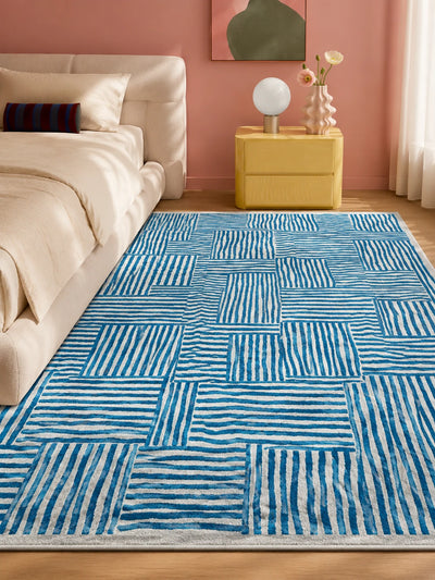 cobalt stripe block rug beside a cream bed and yellow nightstand against a pink wall