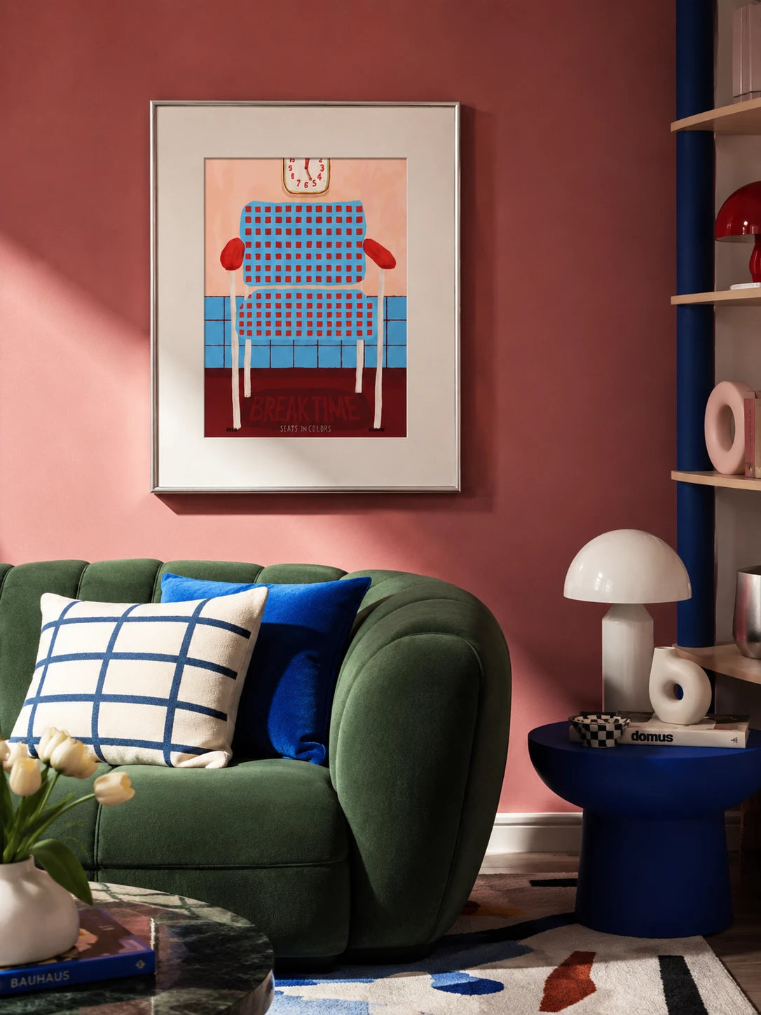 Break Time armchair art print in a silver frame on a dusty pink wall above a green boucle sofa