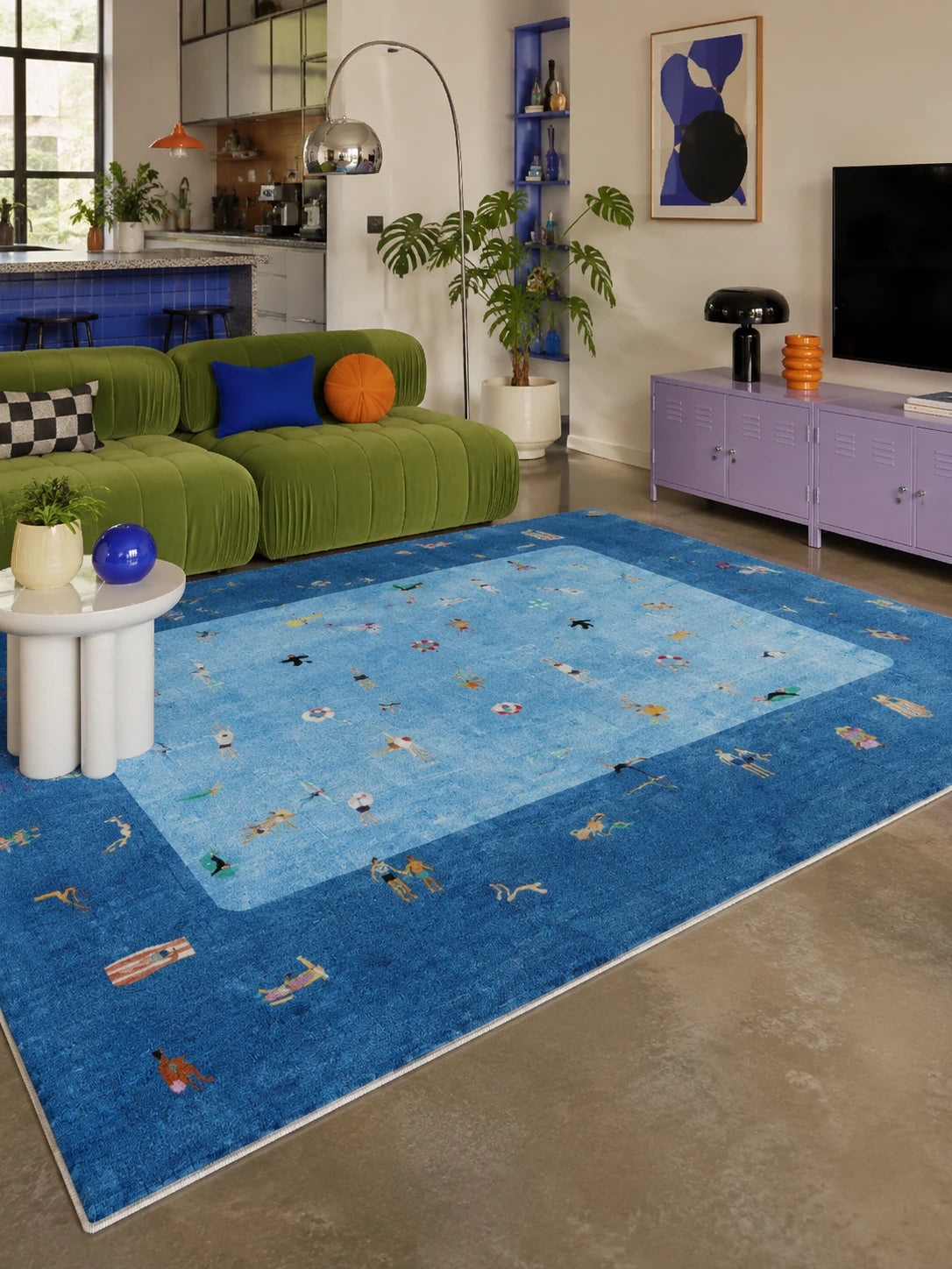 aerial pool scene rug with tiny swimmers beside a green velvet sofa in an open living room