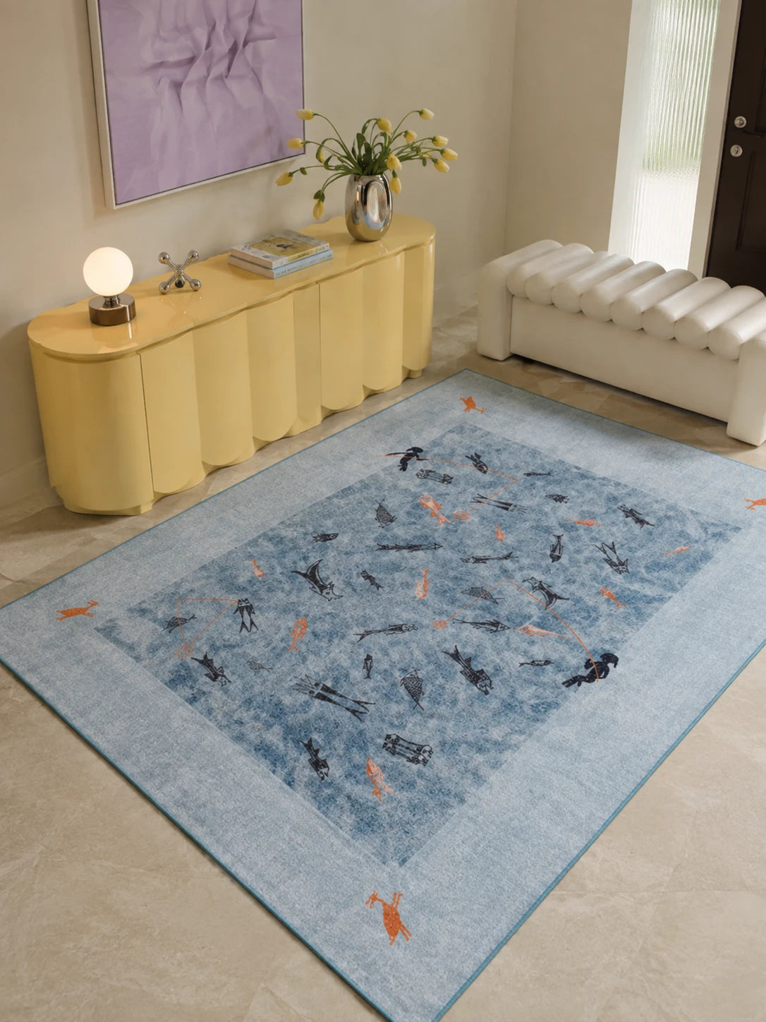blue pictograph fishing rug in a bright entryway beside a yellow scalloped sideboard