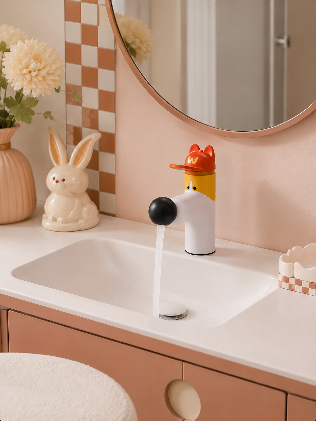 corgi faucet running water into a white basin beside a ceramic bunny and peach checkered tiles