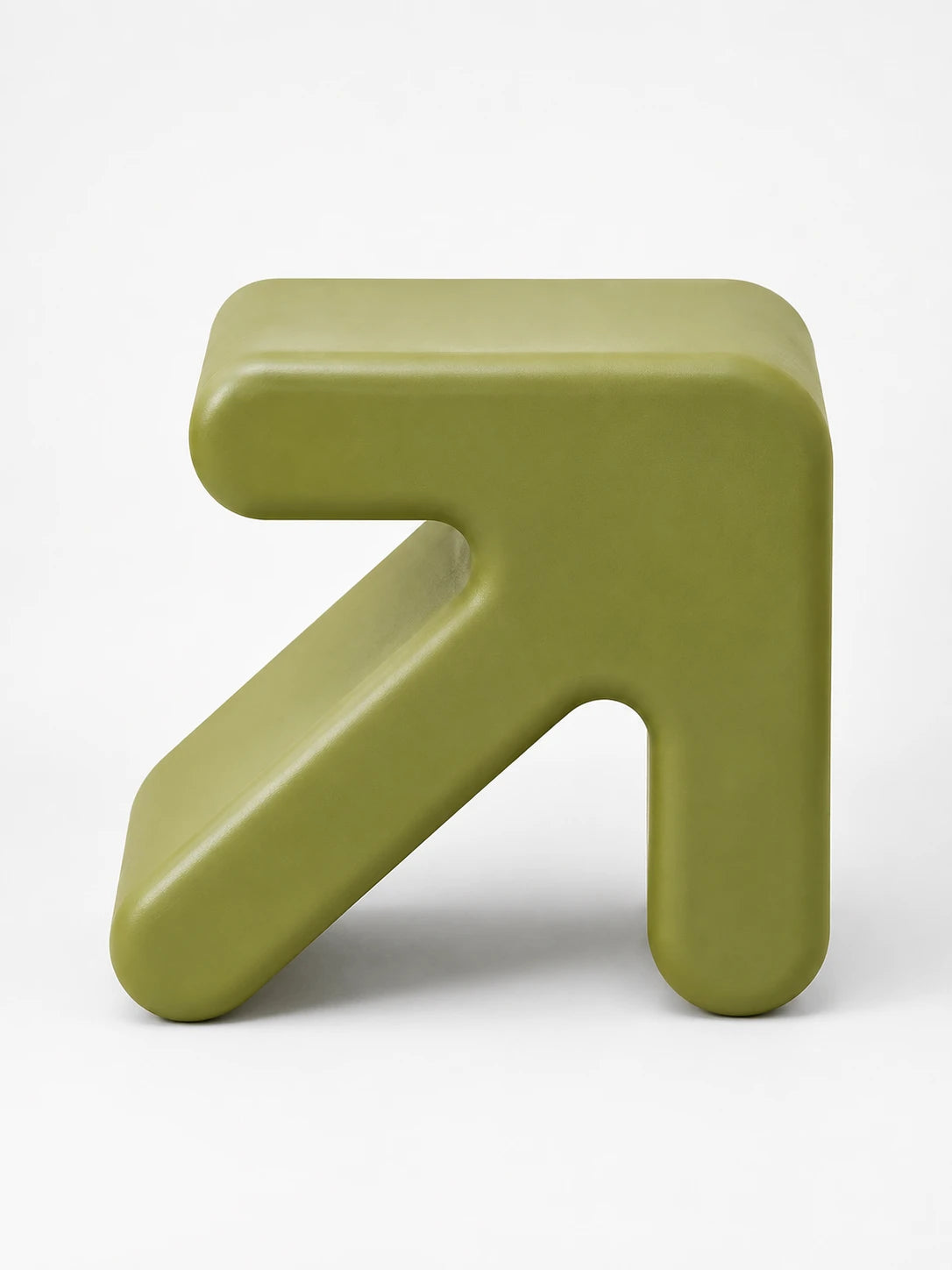 olive green arrow-shaped plastic low stool photographed from the side