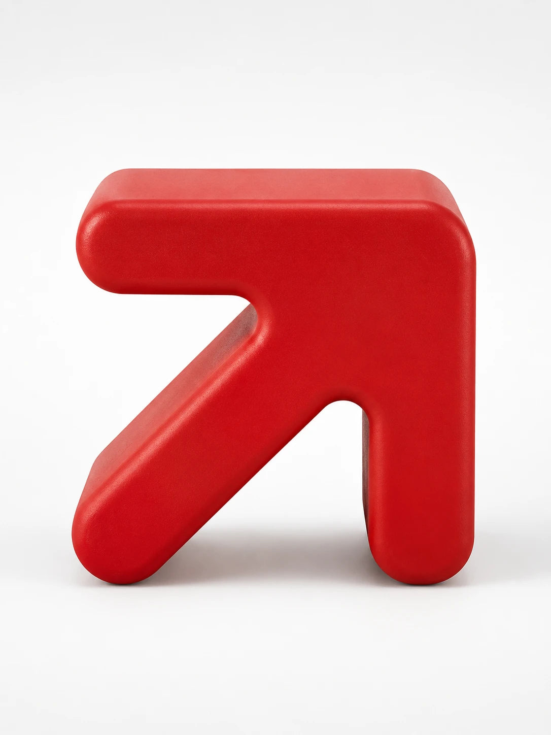 bright red arrow-shaped plastic stool with rounded edges on a white background