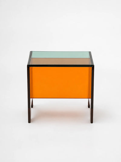 translucent orange acrylic mini stool with a green-tinted top and dark edge lines on a white background