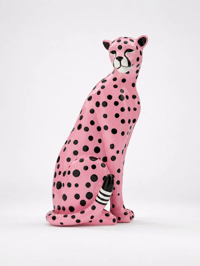 glossy pink resin leopard statue seated with black polka dots, a white muzzle and a striped tail tip