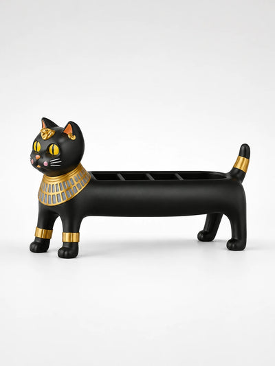 matte black resin Egyptian cat jewelry holder with a gold collar and cuffs and open compartments along its back