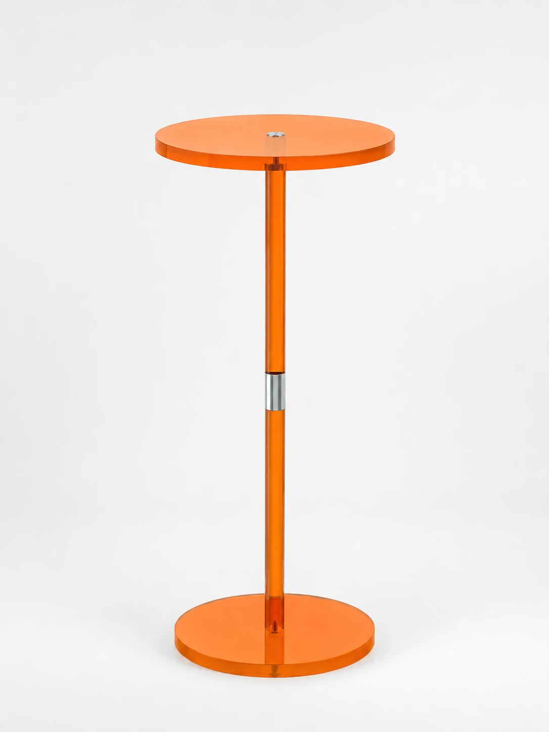 translucent orange acrylic pedestal side table with a round top, slim stem and disc base on a white background