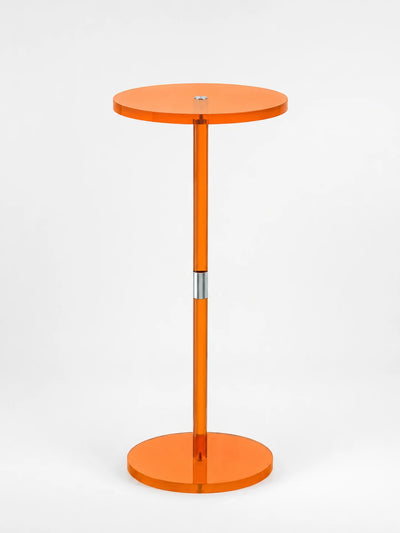 translucent orange acrylic pedestal side table with a round top, slim stem and disc base on a white background