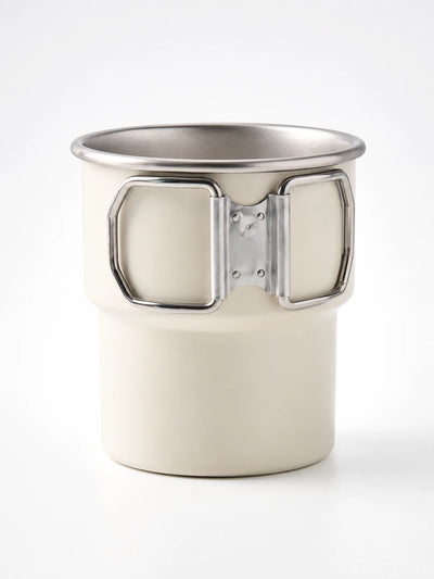 cream white matte stainless steel camping mug with a stepped base and folding wire handles