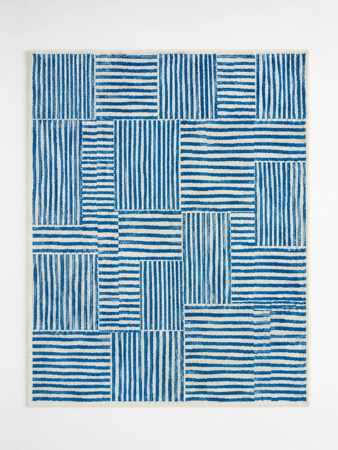 blue and cream area rug with staggered blocks of wavy cobalt stripes alternating direction