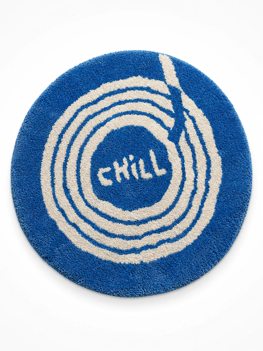 cobalt blue round tufted rug with hand drawn white spiral groove and CHILL lettering in the center