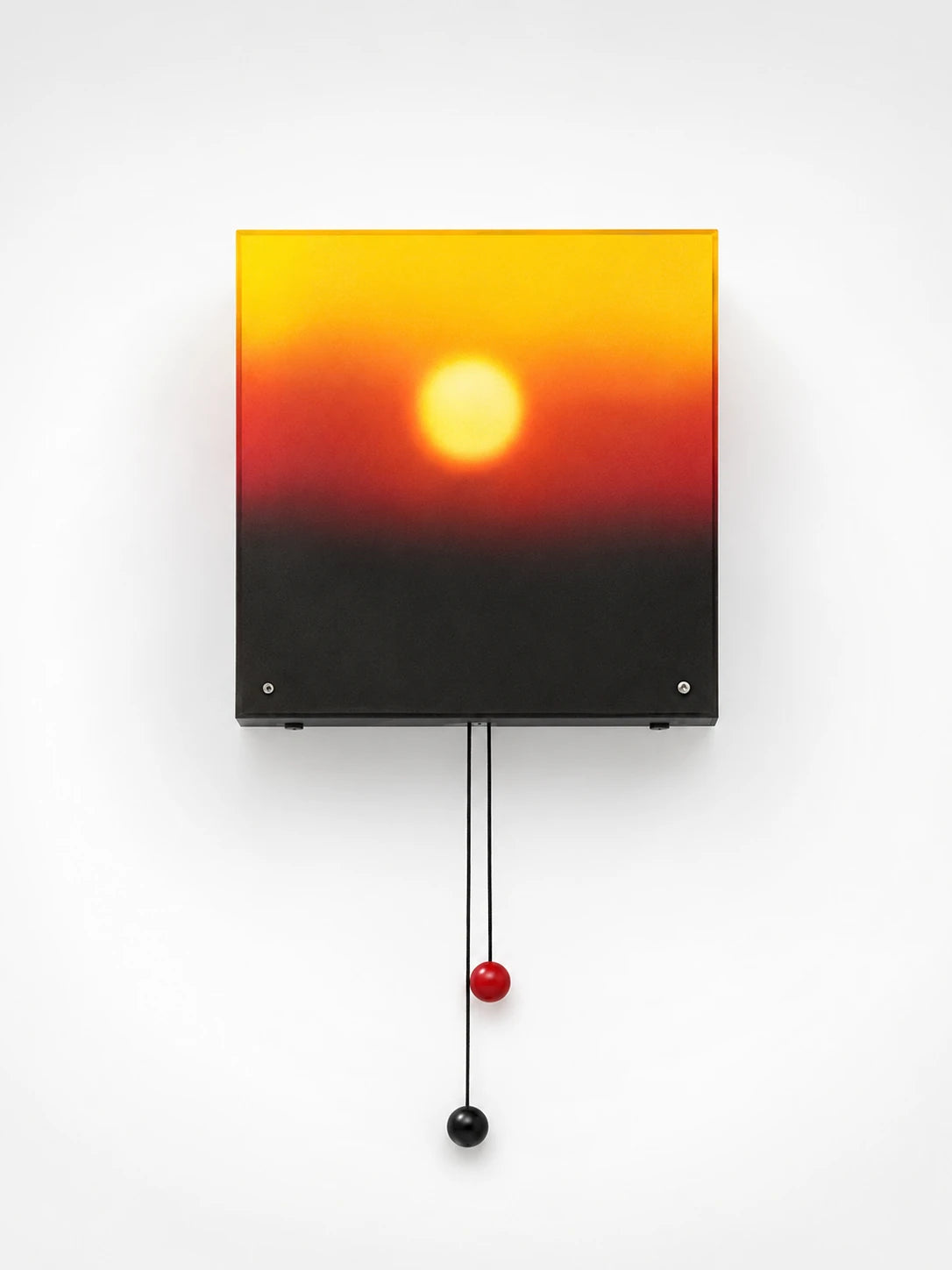square sunset lightbox wall lamp glowing yellow to red over a dark horizon, with red and black pull balls