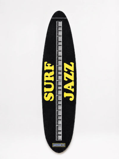 black surfboard runner rug with yellow lettering and a white piano-key stringer stripe