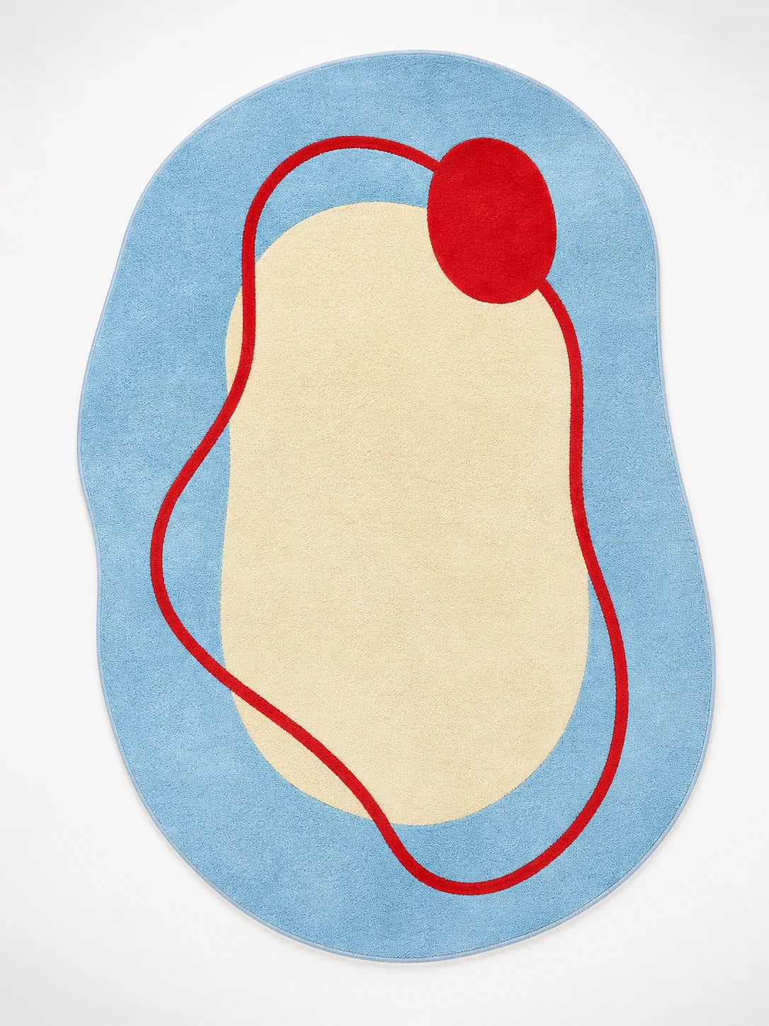 irregular blob-shaped rug with sky blue field, cream center, and red squiggle line ending in a red dot