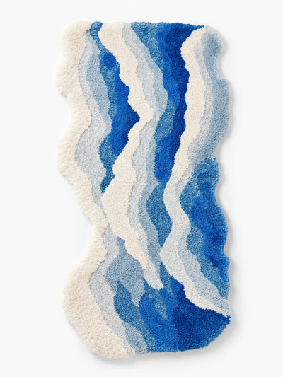 free form blue ocean wave bedside rug with raised cream shag foam bands and gradient blue plush pile