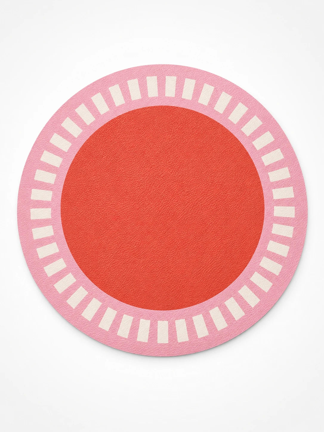 pink round placemat with a cream tick ring around a tomato-red centre, flat lay